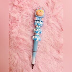 Blue beaded pen with Amalis figure.